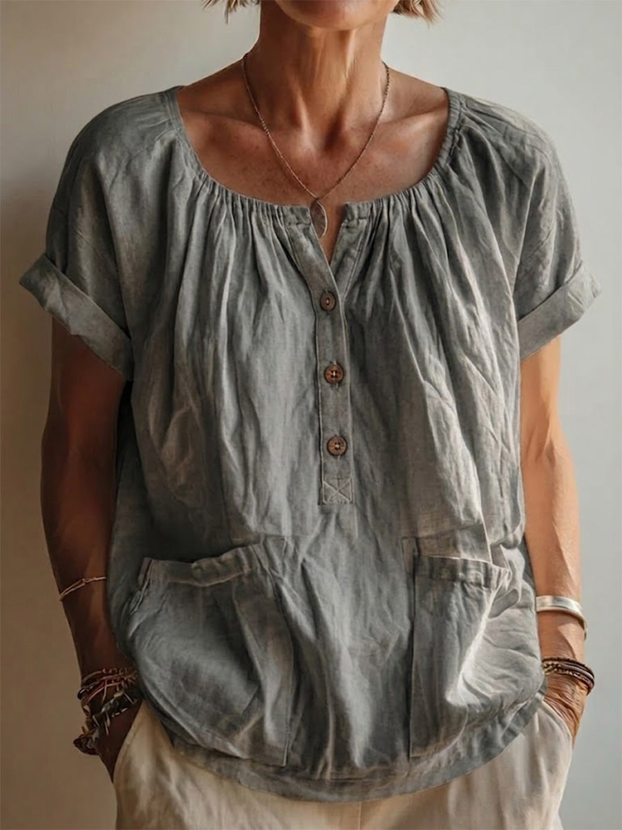Garment-washed Grey Cotton-linen Top Featuring A Gathered U-neck, Partial Button Placket, Rolled Cuffs, And Short Sleeves.