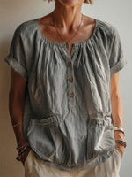 Garment-washed Grey Cotton-linen Top Featuring A Gathered U-neck, Partial Button Placket, Rolled Cuffs, And Short Sleeves.