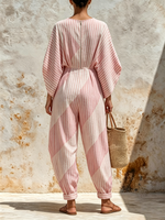 Vertical-striped V-neck Cotton Jumpsuit Featuring A Cinched Waist, Rolled Cuffs, And Loose-fitting Batwing Mid-length Sleeves.