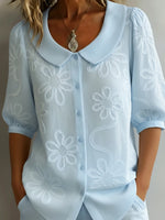 Camicia vintage con colletto Peter Pan e ricami floreali.